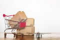 Shopping cart cartons and airplane. International shopping and Worldwide shipping concept