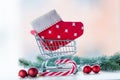 Shopping cart with christmas sock and lolipop Royalty Free Stock Photo