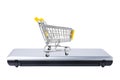 Shopping cart on closed laptop isolated on white. Electronic commerce concept Royalty Free Stock Photo