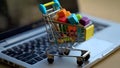 Shopping cart with colorful pencils on laptop keyboard. Online shopping concept Royalty Free Stock Photo