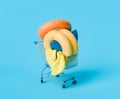 Shopping Cart with Colorful Pool Floats on Blue Background
