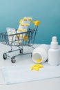 Shopping cart with compounded prescription medications shipped from a mail order pharmacy on a blue background. Vertical