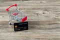 Shopping cart with credit card. Stay home shopping and electronic payment with credit card concept. Small shopping cart with credi Royalty Free Stock Photo