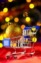 Shopping cart with decorative ball Royalty Free Stock Photo