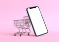 Shopping cart with empty smartphone screen on a pink background