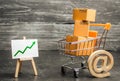 Shopping cart filled with boxes, email symbol and stand with green up arrow. shopping online. Growth rate of Internet sales Royalty Free Stock Photo