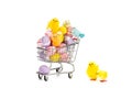 Shopping cart filled with colored easter eggs and happy colored easter chickens. Royalty Free Stock Photo