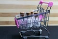 Shopping cart filled with homeopathic glass bottles with cork on wood and dark background. Online Homeopathic medicine concept
