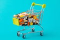 Shopping cart filled with pills. Blue background. Concept: full set of medicines in the store. Copy space for text Royalty Free Stock Photo