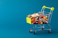 Shopping cart filled with pills. Blue background. Concept: full set of medicines in the store. Copy space for text Royalty Free Stock Photo