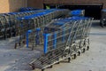 Shopping cart in front of convenience store near the parking lot. Royalty Free Stock Photo