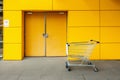 Shopping cart in front of emergency fire exit door and aluminum Royalty Free Stock Photo