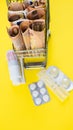 shopping cart full of medicine with pills and capsules and euro banknotes. money . drug cost concept Royalty Free Stock Photo