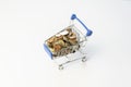 Shopping cart full of coins.Shopping concept with shopping supermarket trolley on isolated white background.E-commerce, business Royalty Free Stock Photo