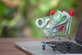 A shopping cart full of euro banknotes on a computer keyboard on a desk Royalty Free Stock Photo