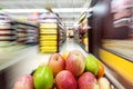 A shopping cart full of fruit on store shelves Royalty Free Stock Photo