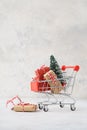 Shopping cart full of gift boxes and a Christmas tree Royalty Free Stock Photo