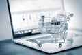 Shopping cart full of homeopathic remedies on laptop Royalty Free Stock Photo