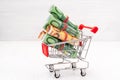 Shopping cart full of roll Euros Royalty Free Stock Photo