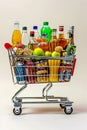 Shopping cart full of various foods and drinks on white background Royalty Free Stock Photo