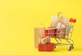 Shopping cart full of various gift boxes and paper bags Royalty Free Stock Photo