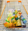 Shopping cart with groceries in a supermarket. Royalty Free Stock Photo