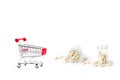 Shopping cart with herb capsule pills spilling out off bottle isolated on white background.Image for Medical Concept. Royalty Free Stock Photo