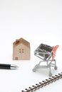 Shopping cart and house on white background. Buying new house, Royalty Free Stock Photo