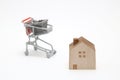 Shopping cart and house on white background. Buying new house, Royalty Free Stock Photo