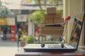 Shopping cart on laptop keyboard, e-commerce, digital purchase. Royalty Free Stock Photo