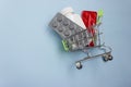 Shopping cart loaded with pills on blue background. The concept of medicine and the sale and delivery of drugs. Copy space Royalty Free Stock Photo