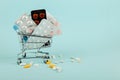 Shopping cart loaded with pills on a blue background. The concept of medicine and the sale of drugs. Copy space Royalty Free Stock Photo