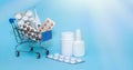 Shopping cart with medicinal pills and thermometer. Spray, vitamins, bottle lying near mini basket on blue background. Pharmacy