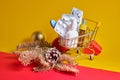 Shopping cart with medicines on yellow-red background, buying medicines before christmas and new year, cold and flu season