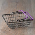 Shopping cart in a minimalist style. Shopping basket at the supermarket. Sale, discount, the concept of shopaholism.