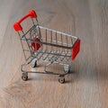 Shopping cart minimalist style. Shopping cart in the supermarket. Sale, discount, the concept of shopaholism.