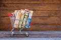 Shopping cart with money from different countries: dollars, euros, hryvnia, rubles Royalty Free Stock Photo