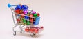 Shopping cart with multicolored christmas balls for decorating christmas tree Royalty Free Stock Photo