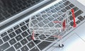 Shopping cart on a notebook keyboard. online shopping