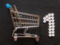 Shopping cart and number one made of pills, Concept care of your health is your priority