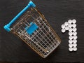 Shopping cart and number one made of pills, Concept care of your health is your priority. Top view