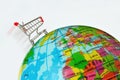 Shopping cart over eath globe - Concept of shopping and global market Royalty Free Stock Photo