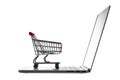 Shopping cart over laptop isolated on white background. E-commerce, business concept Royalty Free Stock Photo