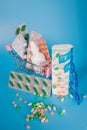 Shopping cart and pills in blisters and plastic container for medicines. Concept of buying medicine online, delivery of Royalty Free Stock Photo