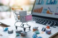 Shopping Cart Placed on Top of a Laptop Computer at the Supermarket, Visualization of targeted online ads driving sales for an e-