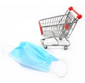 Shopping cart with PPE face mask on white background