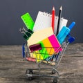 Shopping cart with school supplies. Back to school Royalty Free Stock Photo