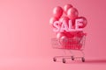 Shopping cart with sign SALE and inflatable helium balloons on pink background. Sale, Black Friday concept, shopping season,