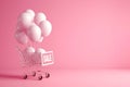 Shopping cart with sign SALE and inflatable helium balloons on pink background. Sale, Black Friday concept, shopping season,