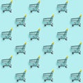 Shopping cart staggered on blue. Seamless pattern